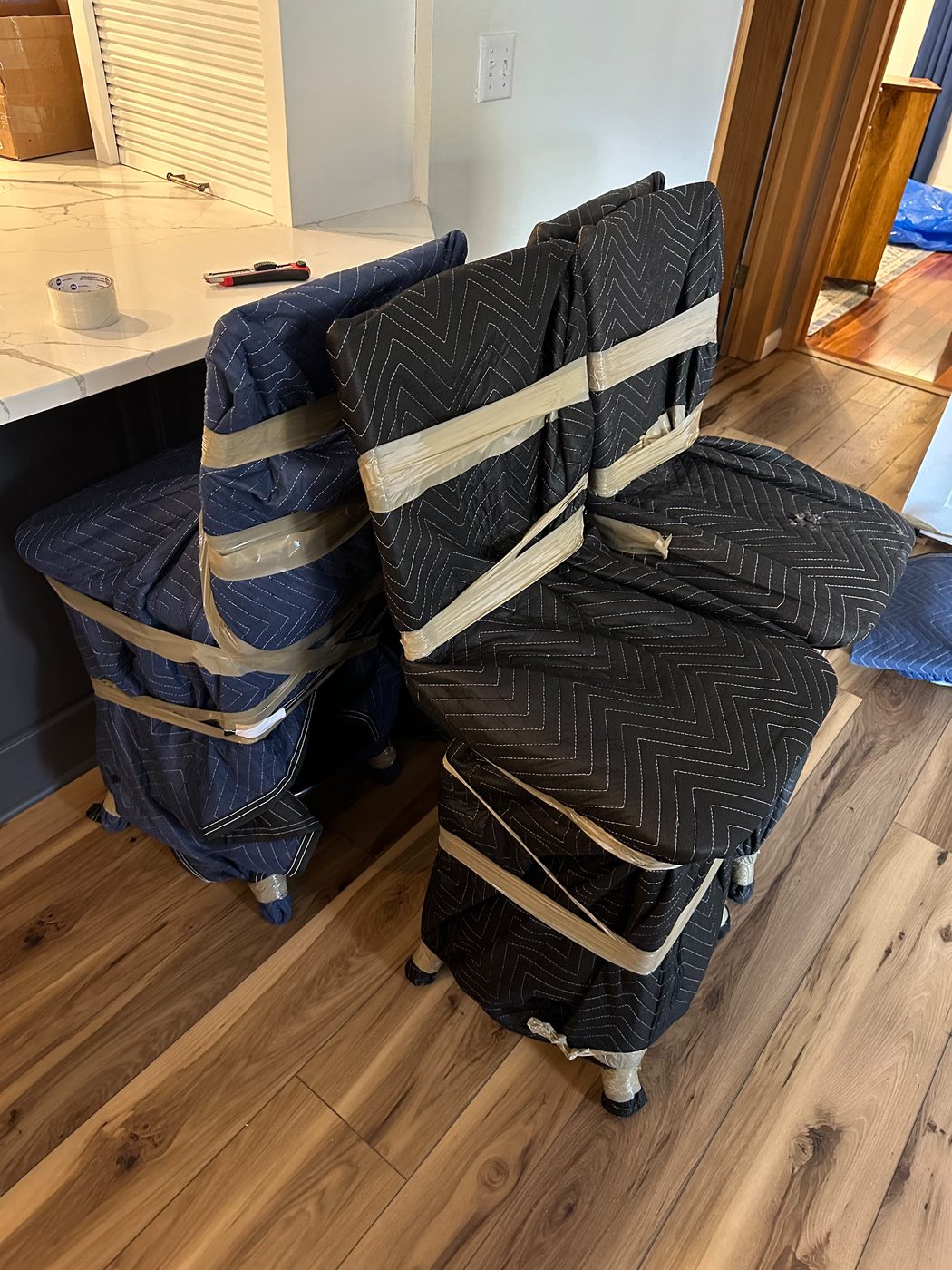 Kitchen chairs wrapped in moving blankets before transport for a Chicago to Las Vegas move